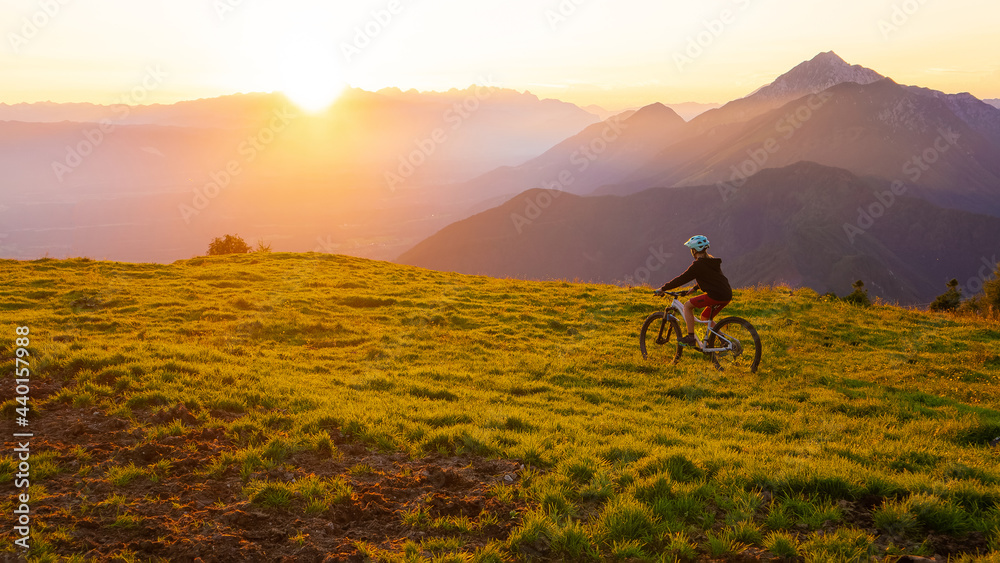 Girl child riding mountain bike into the sunset. Beautiful golden summer light. Girl child riding mountain bike into the sunset. Beautiful golden summer light.