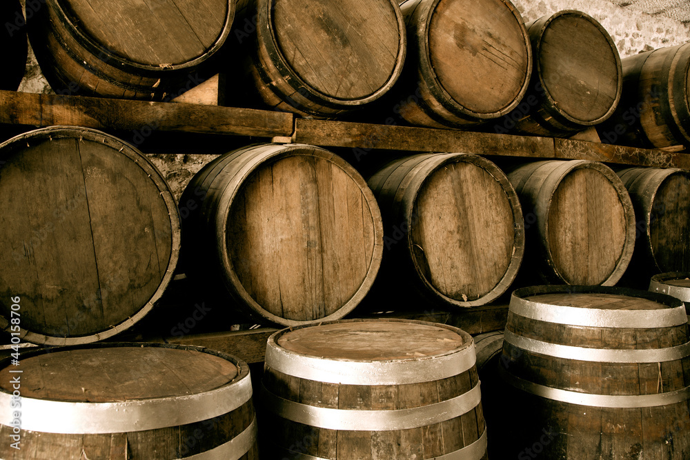 Wine barrels on old cellar. Warm and desaturated tones Wine barrels on old cellar. Warm and desaturated tones