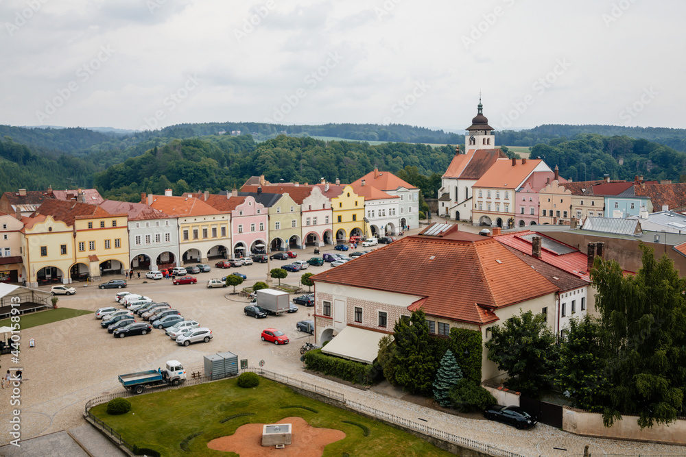 Main Husovo Square, colorful houses on sunny day, renaissance and baroque historical buildings, arcade, Church of the Holy Trinity, medieval town Nove mesto nad Metuji, Czech Republic