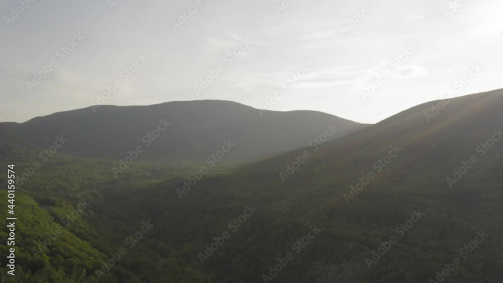 Aerial over vast lush wilderness between mountain range Aerial over vast lush wilderness between mountain range