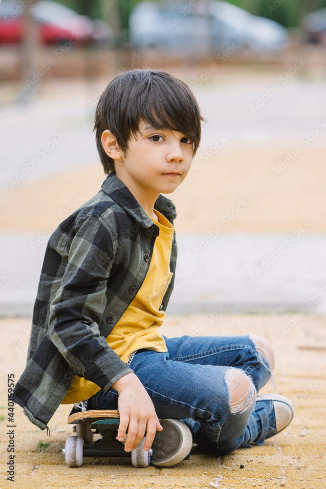 Little boy sitting on skateboard Little boy sitting on skateboard