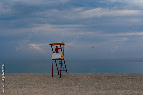 Person in lifeguard tower on the beach