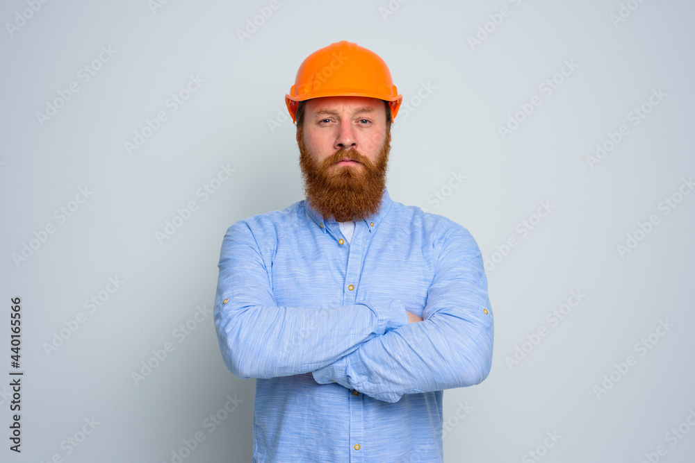 Isolated doubter architect with beard and orange helmet Isolated doubter architect with beard and orange helmet