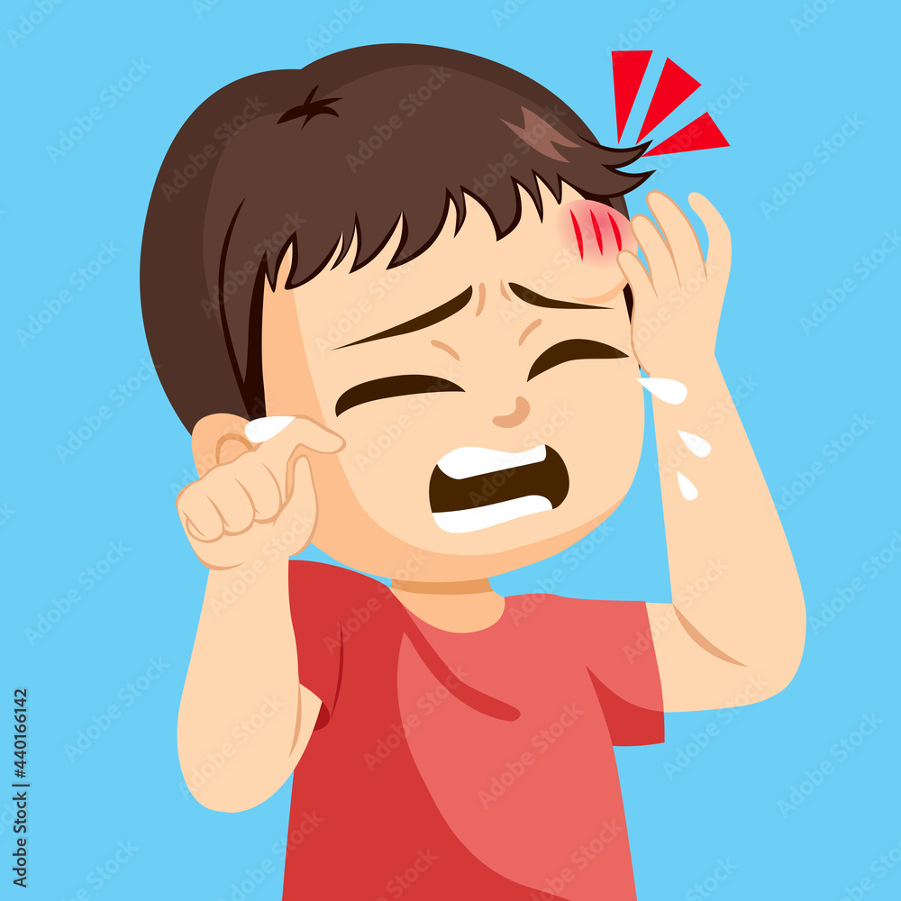 Sad little toddler boy crying touching forehead bump injury Sad little toddler boy crying touching forehead bump injury