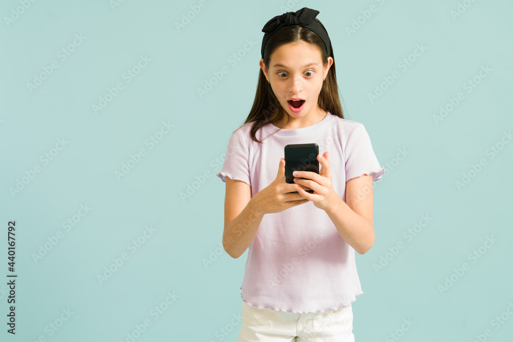 Cute girl watching something exciting on her phone Cute girl watching something exciting on her phone