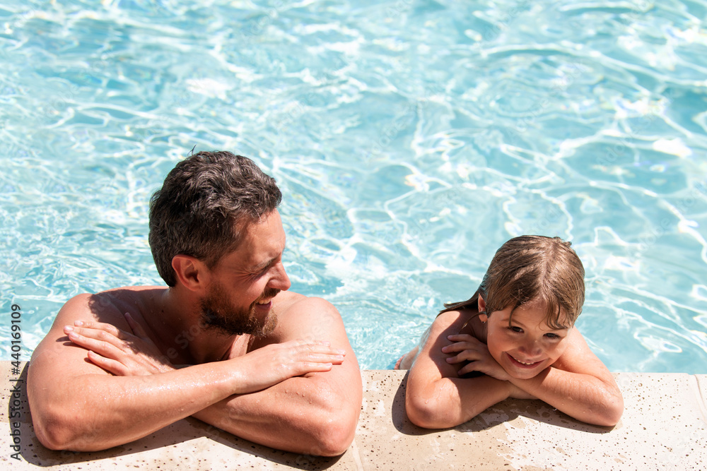 Father and son in pool. Summer resort. Pool party. Boy with dad in swimming pool. Active lifestyle concept. Father and son in pool. Summer resort. Pool party. Boy with dad in swimming pool. Active lifestyle concept.