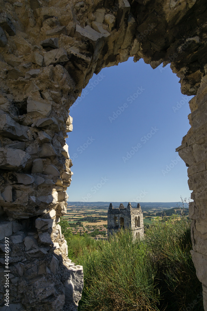 view at tower of eglise saint felix de Marsanne through hole in old ruin wall in Provence, Marsanne, France
