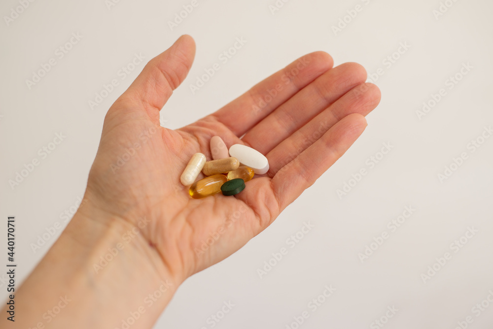 Fertility supplements held in an open hand Fertility supplements held in an open hand