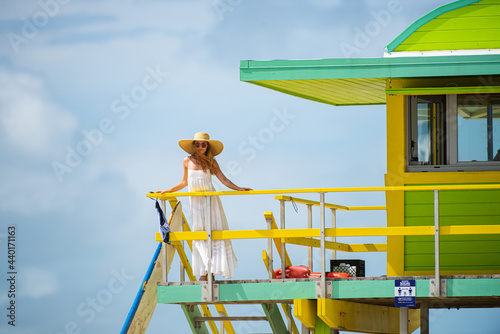 Fashion model posing on the miami beach. Summer dress fashionable woman clothes. Young beautiful hipster woman on tropical vacation, summer trend style.
