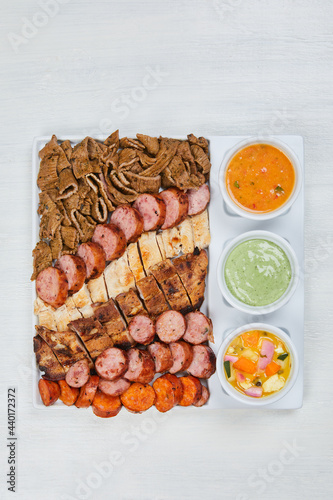 variety of grilled meats and chicken with mayonnaise and sauces