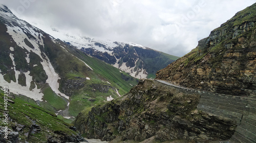 Beautiful snow caped and green mountains and narrow road near rohtang pass in himachal pradesh, India