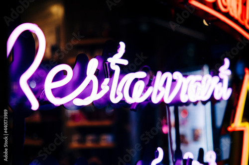 Color Neon Sign Glowing At Night Behind Glass: restaurant sing