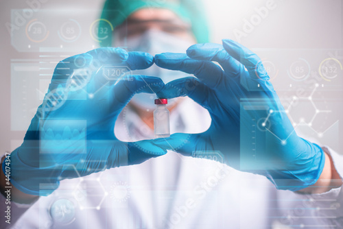Doctor holding vaccine bottle with modern HUD interface screen on hospital background, Innovation and Medical technology.