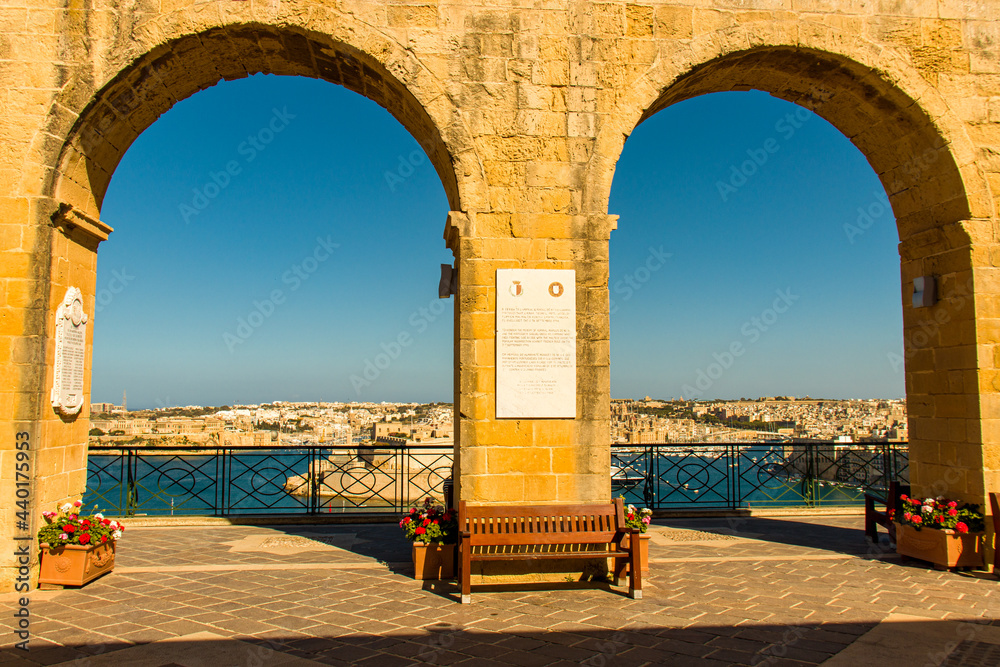 Arch with ancient city in the background and the Mediterranean sea