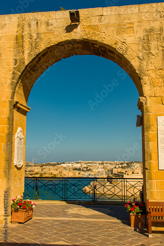 Arch with ancient city in the background and the Mediterranean sea photo