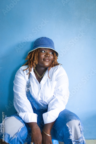 Woman against a blue wall.