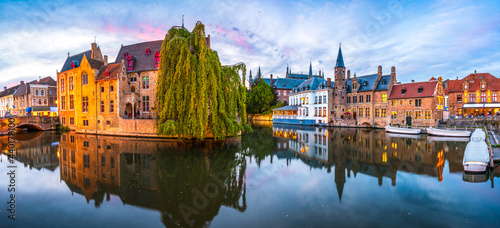 Sunset panorama Brugge city centre, often referred to as The Venice of the North, with famous Rozenhoedkaai illuminated in beautiful twilight, West Flanders province, Belgium photo