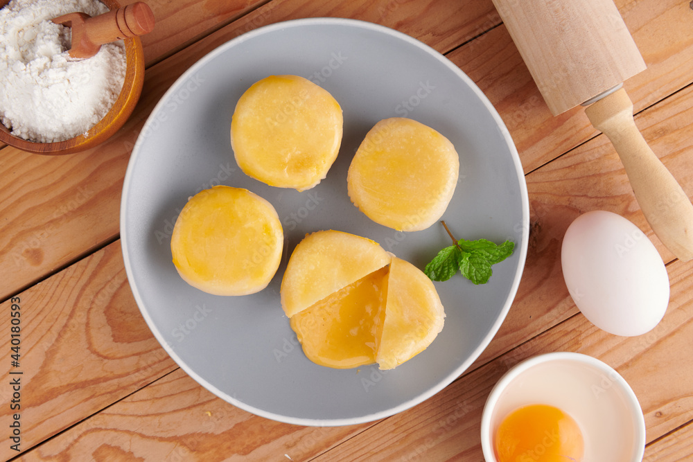 Chinese Dessert Traditional, Sweet Dessert Chinese Style, Asian Dessert. Plate of delicious homemade Chinese pastry with stuffed salted egg yolk lava, selective focus. Chinese Dessert Traditional, Sweet Dessert Chinese Style, Asian Dessert. Plate of delicious homemade Chinese pastry with stuffed salted egg yolk lava, selective focus.