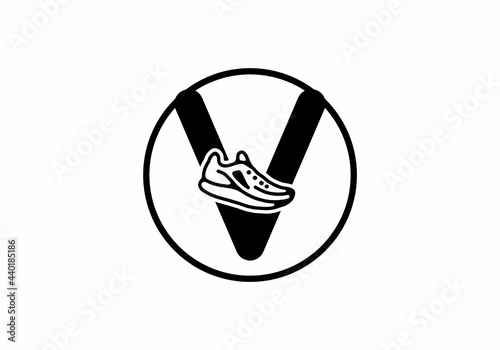 Black V initial letter with shoes in circle