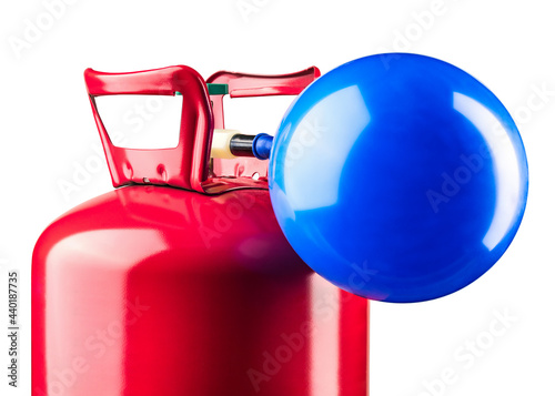 Helium tank. Metal liquefied compressed helium gas container for filling or inflating Balloons good for birthday party, celebration Christmas holidays. Compact Helium tank. Red tank and blue balloon.  photo