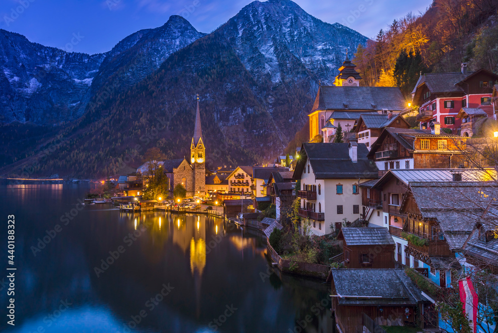 Beautiful Hallstatt township in the evening with water reflection