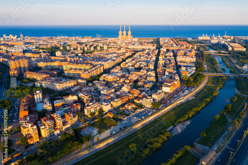 Aerial view of seaside areas of Badalona and Sant Adria de Besos on banks of Besos river on summer day, Catalonia, Spain