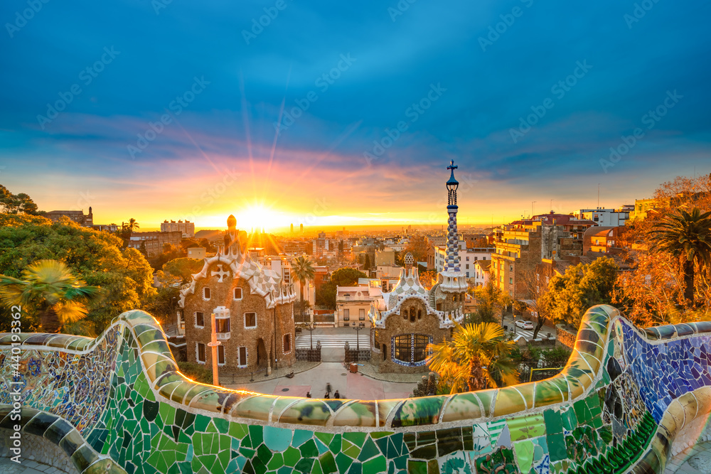 Obraz premium Beautiful sunrise in Barcelona seen from Park Guell. Park was built from 1900 to 1914 and was officially opened as a public park in 1926. In 1984, UNESCO declared the park a World Heritage Site