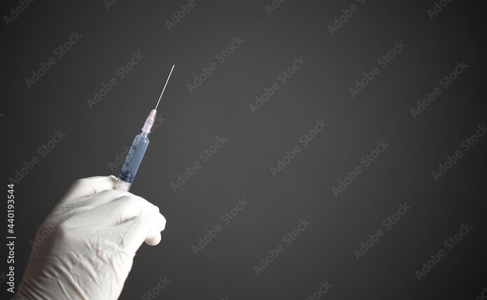 Vaccine concept.Close up hand holding syringe make injection to patient in medical mask. Vaccine concept.Close up hand holding syringe make injection to patient in medical mask.