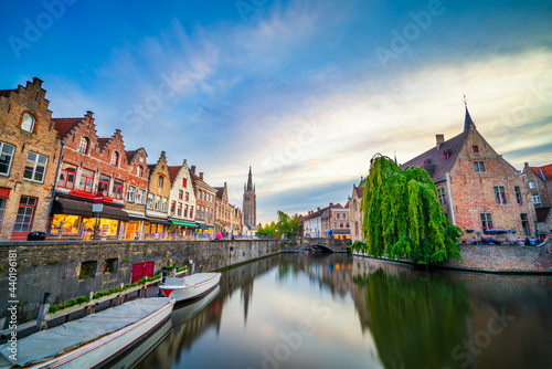 Cityscape of Bruges at sunset with Saint Salvator church tower in the background 