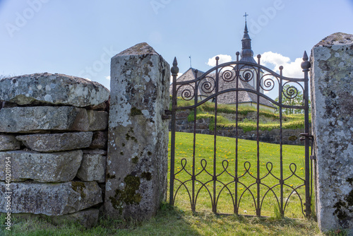 Old iron Gate Entrance in Stonewall or ruin structure to church photo