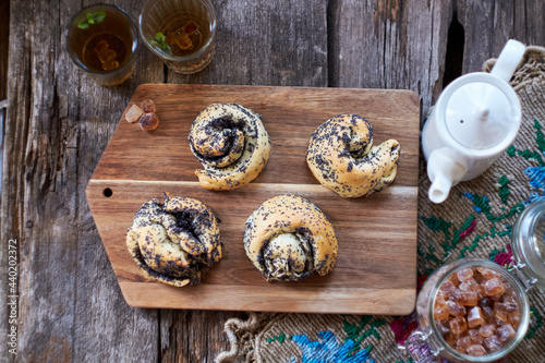 Poppy seed buns. Side view  wooden background. Herbal tea.