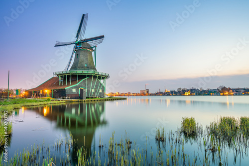 Old Dutch windmill at Zaanse Schans village on sunset. Netherlands 
