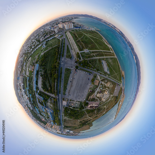 Novorossiysk, Russia. The central part of the city. Sudzhukskaya Spit. Sunset. 360 degree aerial panoramic asteroid photo