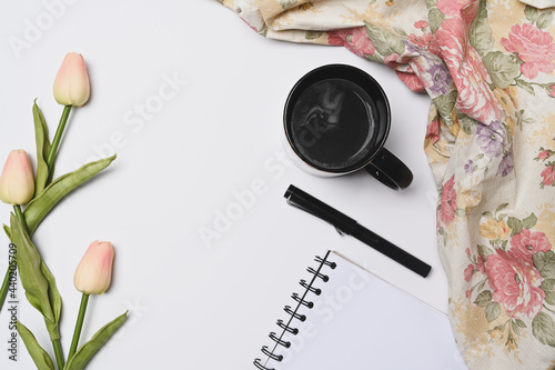 Empty notebook, coffee cup, pen and pink tulips on white background. #440205709