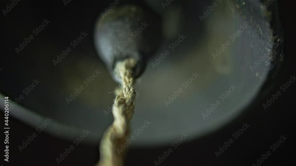 The bell of a small metal bell. The old bell rings.