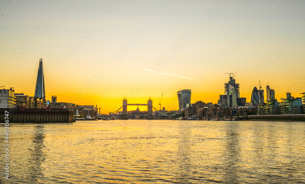 London skyline at sunset including Tower Bridge and skyscrapers at financial district
