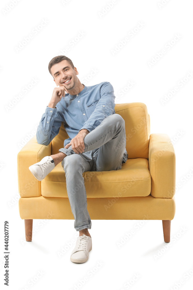 Young man sitting in armchair on white background Young man sitting in armchair on white background