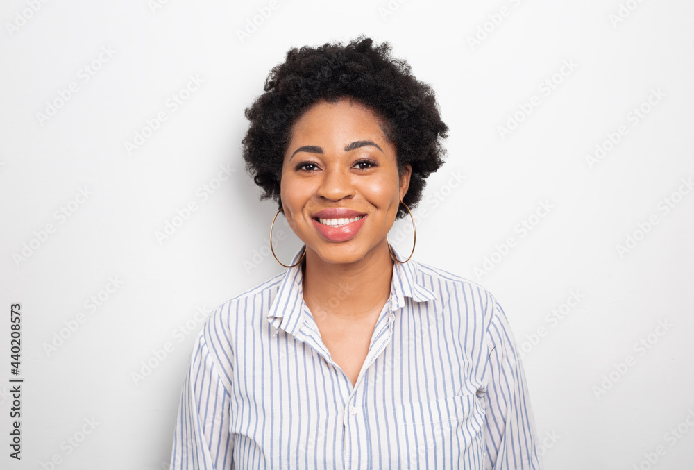 Portrait of a smiling African American young woman. Happy business black female on a white background. Portrait of a smiling African American young woman. Happy business black female on a white background.