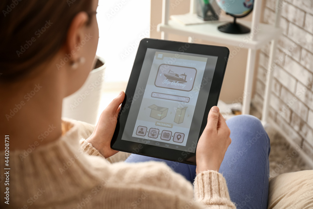 Woman holding tablet computer with open page of delivery service application at home, closeup Woman holding tablet computer with open page of delivery service application at home, closeup