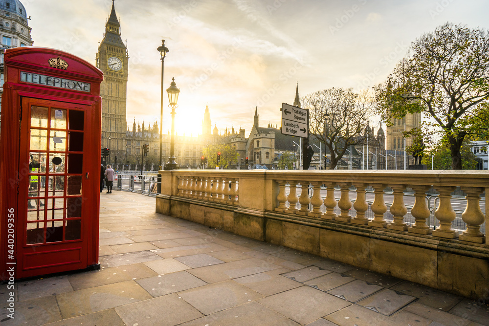 Fototapeta premium Red telephone booth and Big Ben at sunrise in London. England