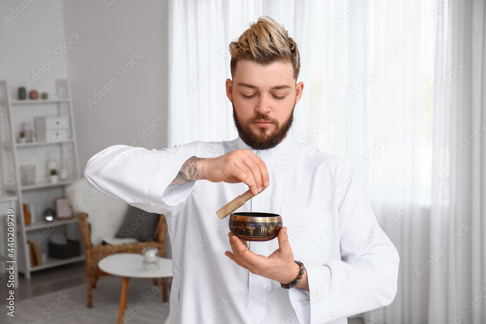 Reiki master working with Tibetan singing bowl Reiki master working with Tibetan singing bowl