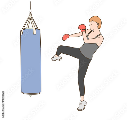 A female boxer is kicking a punching bag. hand drawn style vector design illustrations.