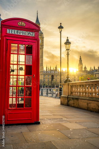 Red telephone booth at sunrise in London. England