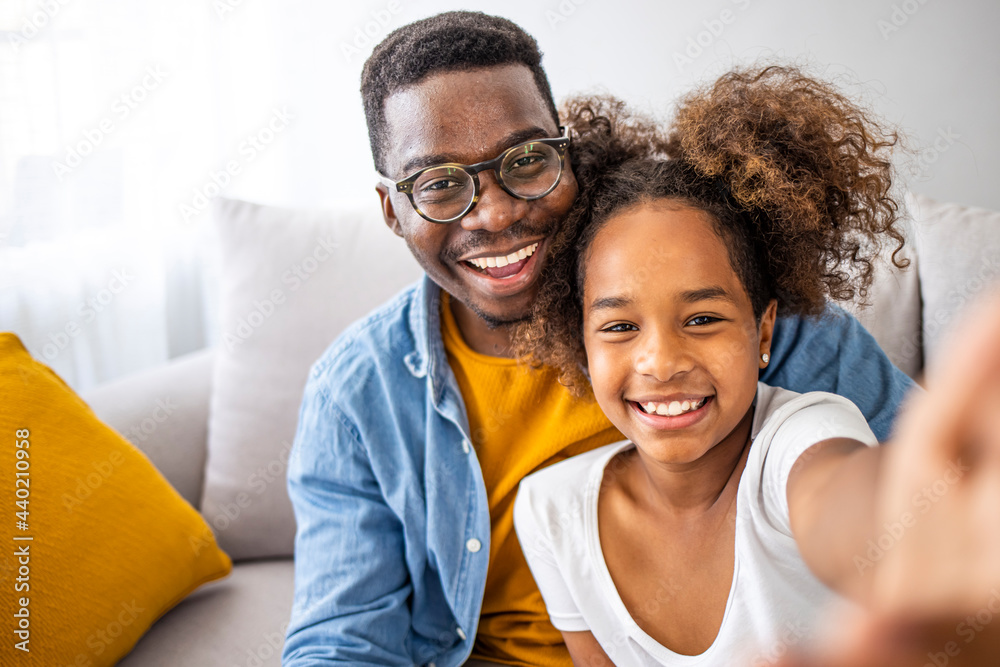Funny selfie with dad. Self portrait of young father and his little daughter taking selfie while sitting on the floor in bedroom. Family time. Happy father taking selfie with his cute daughter at home Funny selfie with dad. Self portrait of young father and his little daughter taking selfie while sitting on the floor in bedroom. Family time. Happy father taking selfie with his cute daughter at home