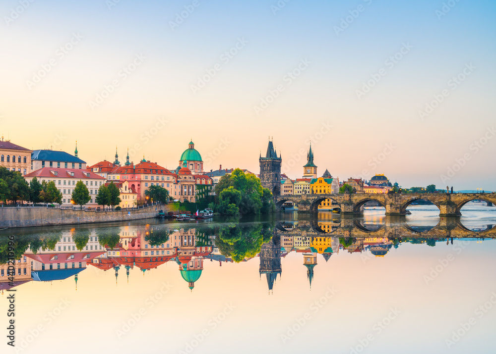 Charles bridge at sunrise with reflection in Prague, Czech Republic