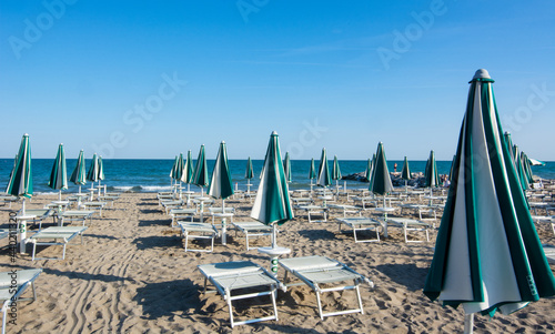 the beach umbrellas still closed early in the morning © corradobarattaphotos