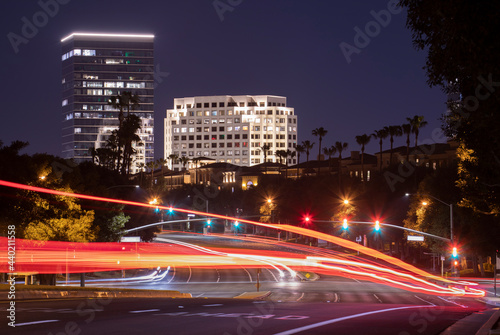 Twilight evening view of traffic streaming by the downtown skyline of Irvine, California, USA. photo