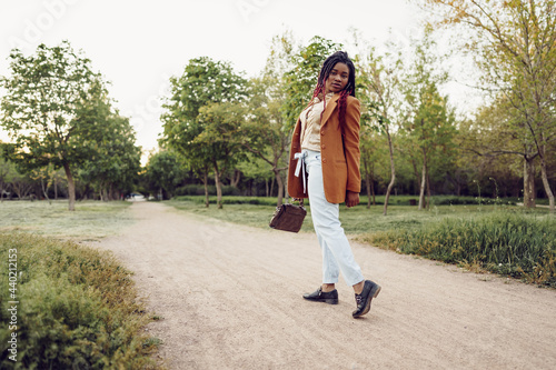 Young african american woman having a walk in a park