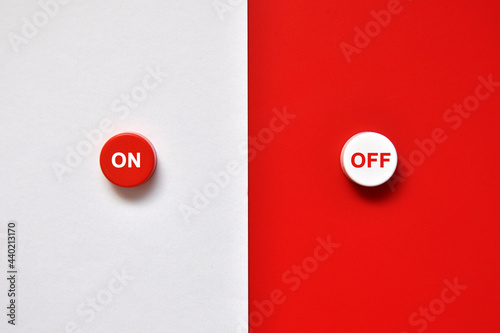 Red and white buttons for turning something on and off. photo
