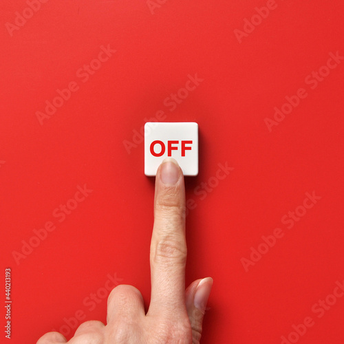 The person presses the red mute button . Turn something off